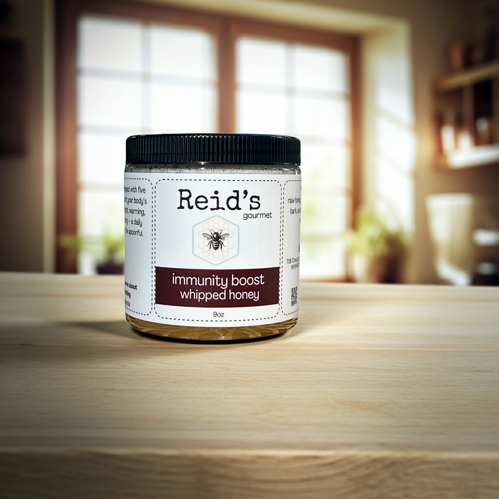 Jar of Reid's immunity boost whipped honey on a wooden surface with a blurred background