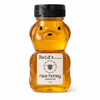 Honey bear bottle with Reid's Gourmet label on a white background