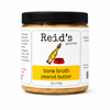 A jar of bone broth peanut butter for dogs on a white background