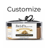 Reid's Gourmet mini peanut butter gift box with a black ribbon on a white background.