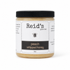 Jar of Reid's peach whipped honey on a white background