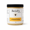 Jar of Reid's Gourmet whipped honey on a white background