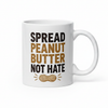 White mug with 'Spread Peanut Butter Not Hate' text and peanut illustration on a white background